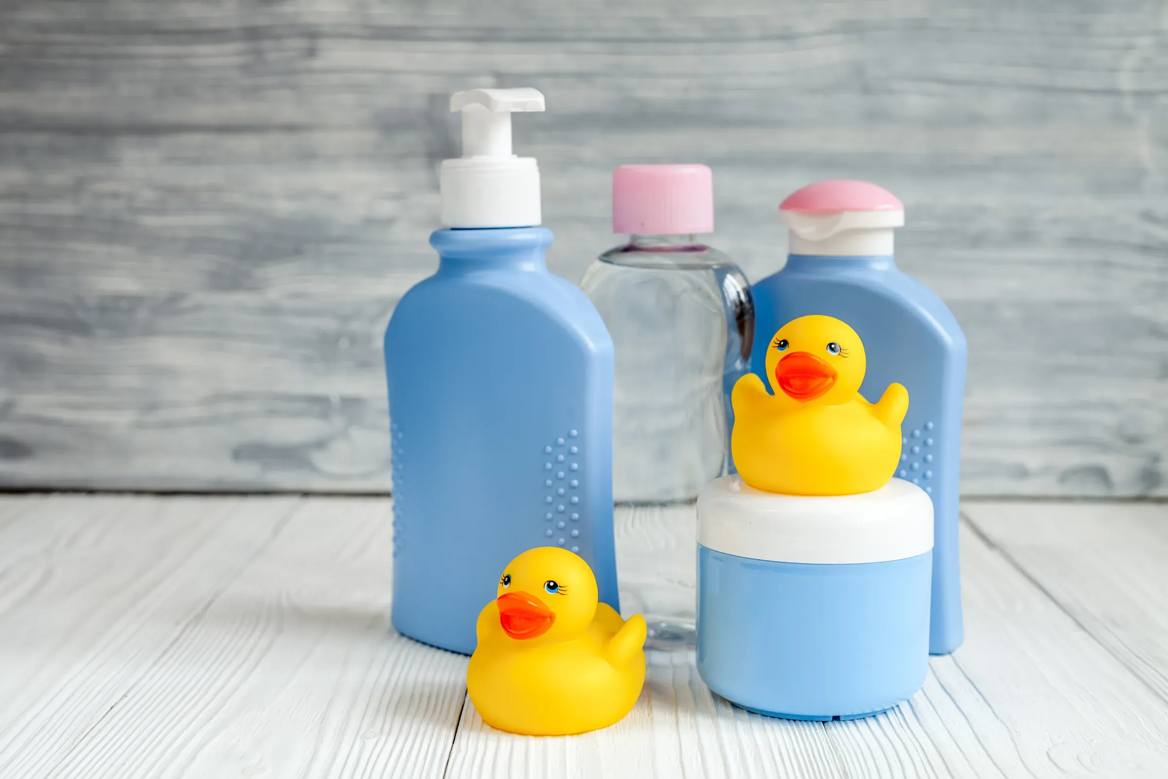 Baby organic cosmetic for bath on wooden bakground, baby skincare ecommerce