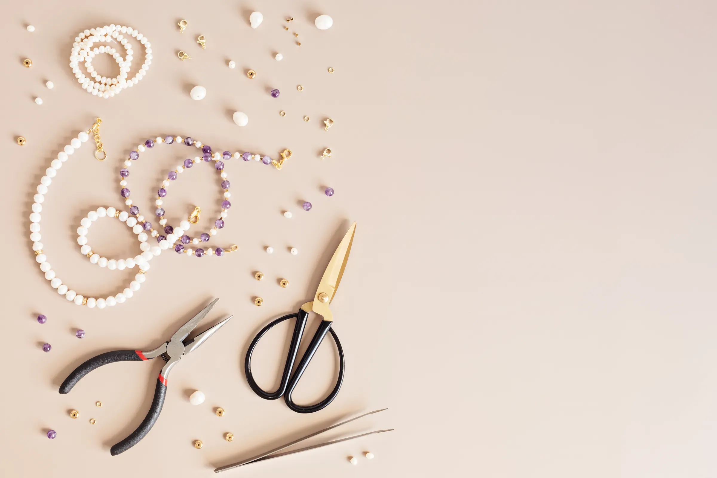 Jewelry making flatlay with semi-precious stone beads and tools. Handmade jewelry, small business, hobby, beading & jewelry-making supplies ecommerce