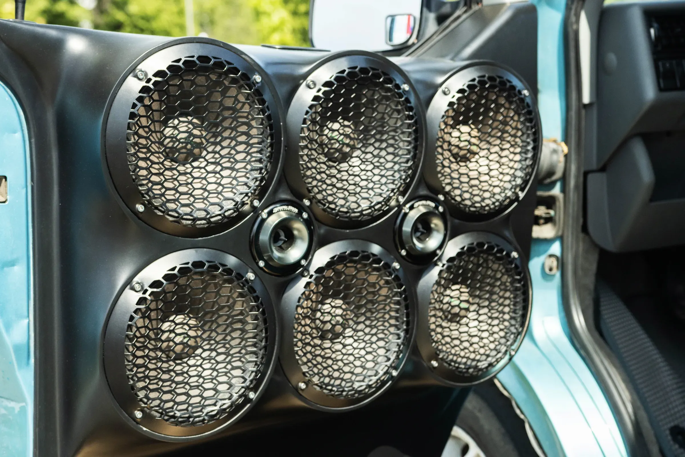 Custom car door with multiple audio speakers installed for powerful sound system, featuring six main speakers, car audio ecommerce