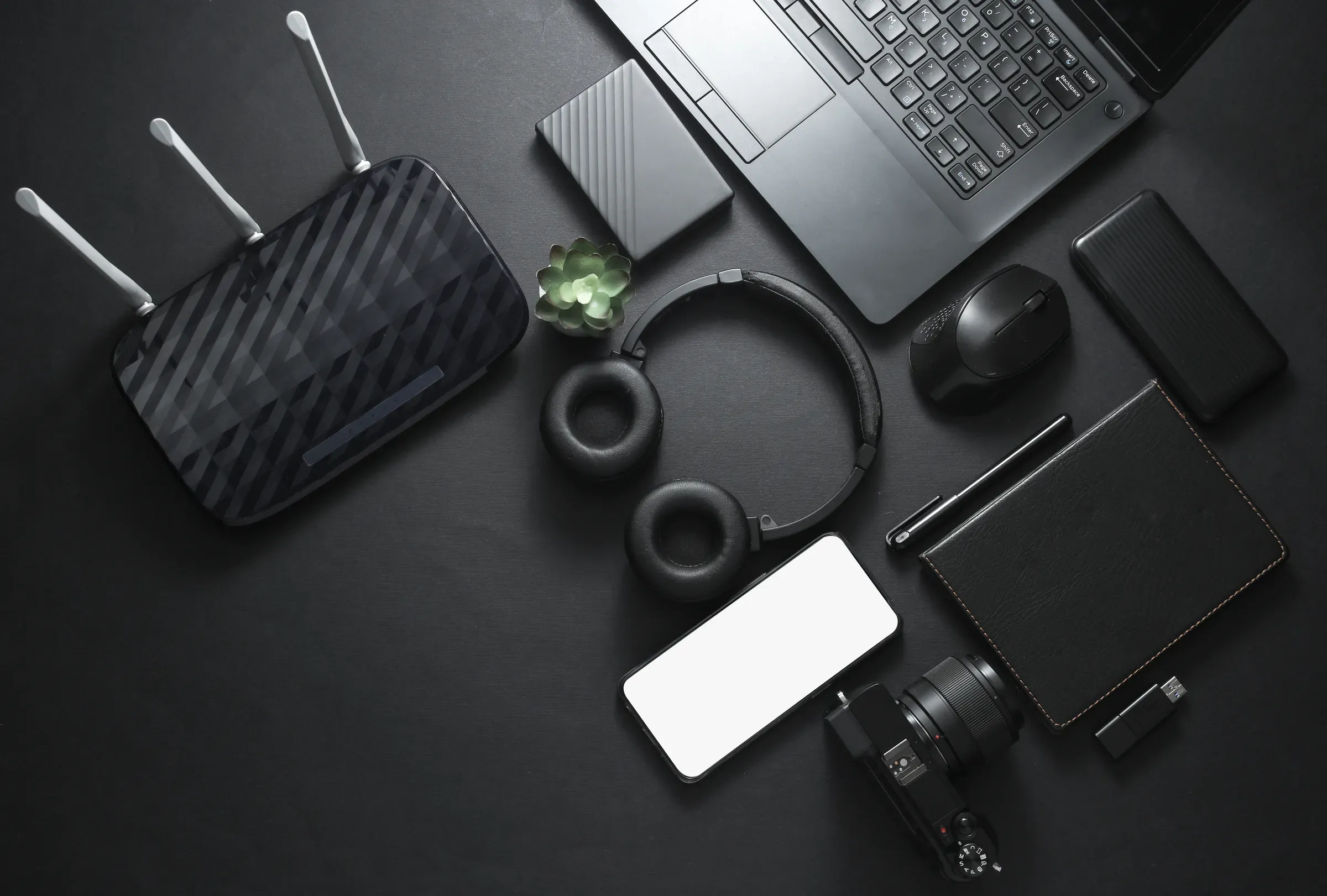 Modern gadgets and accessories in black. Laptop, camera, smartphone, stereo headphones, notepad, external, electronics & gadgets ecommerce
