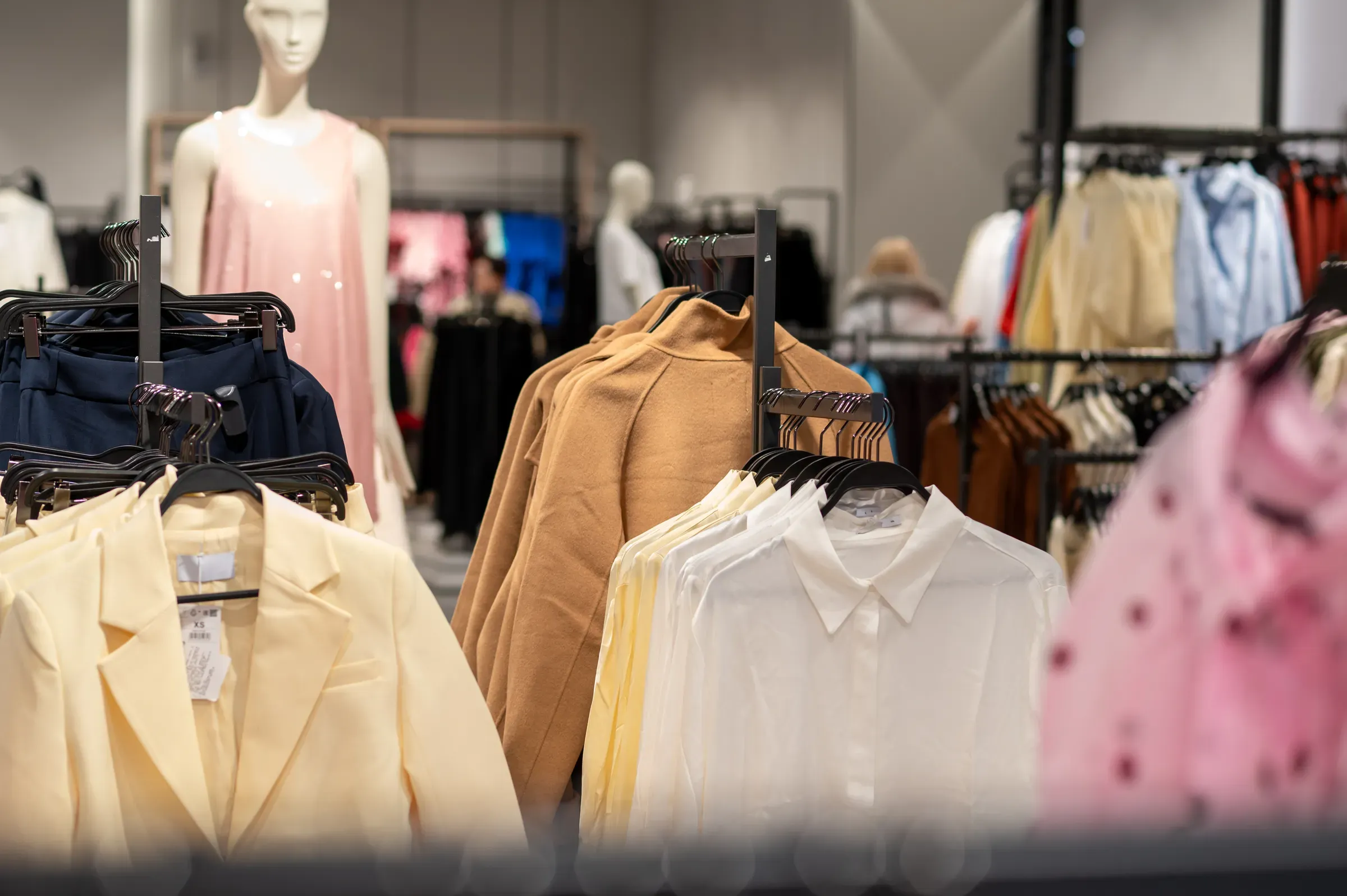 Fashion Retail Store Interior with Pastel Blazers and Shirts on Racks in Modern Clothing Boutique, fashion & apparel ecommerce