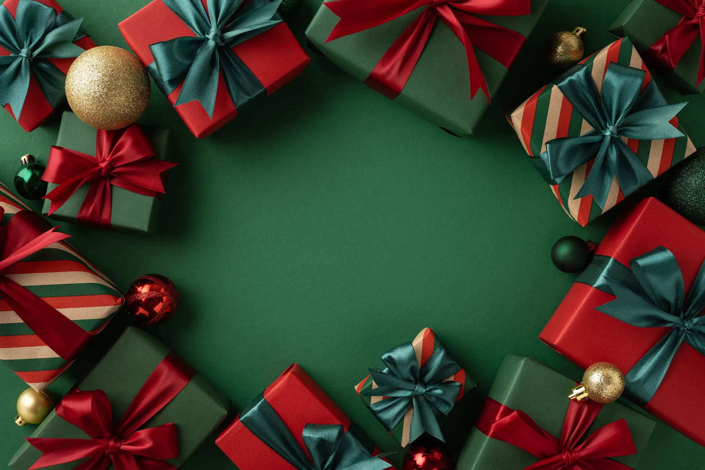 Christmas-themed image displaying beautifully wrapped gifts with red and green ribbons on a festive green, gifts, flowers & occasions ecommerce