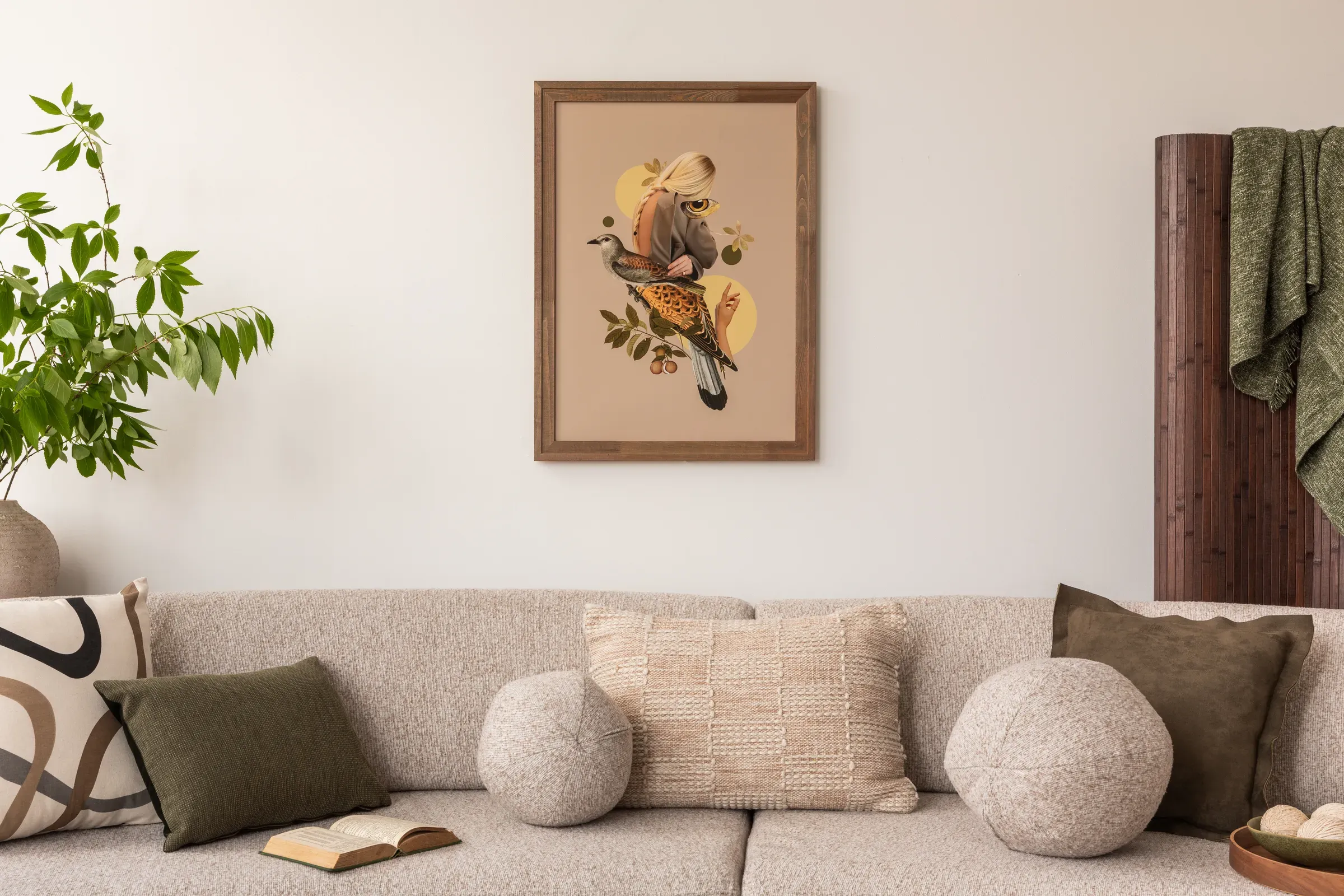 Cozy living room with a beige sofa adorned with textured and patterned pillows. A framed art piece depicting, home decor & wall art ecommerce