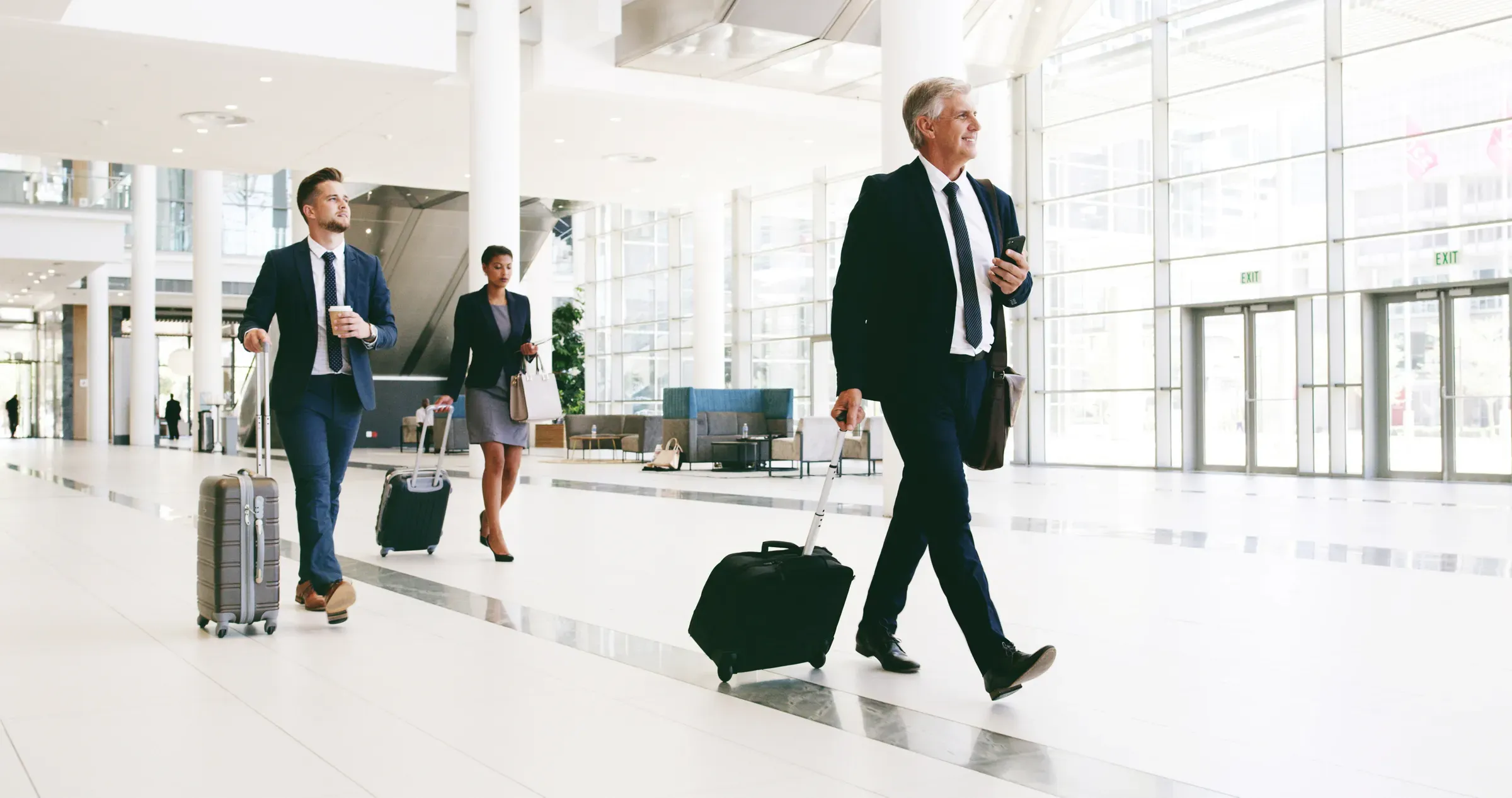 Mature businessman, happy and suitcase at airport for international conference in lobby. Person, attorney and, luggage ecommerce