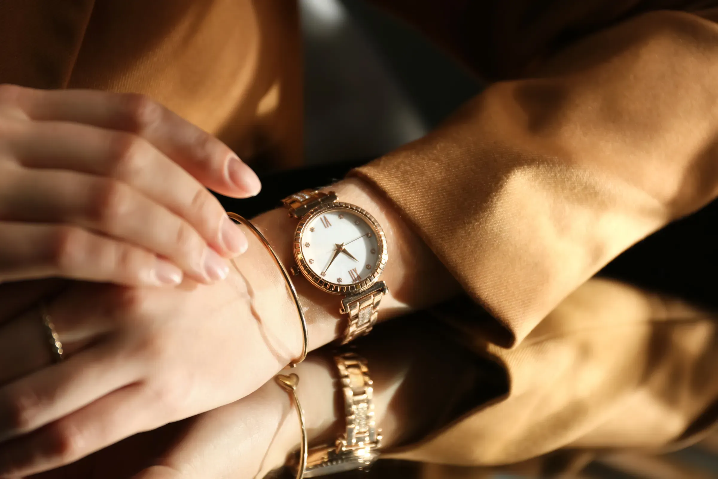 Woman wearing luxury wristwatch near mirror, closeup, luxury watches ecommerce
