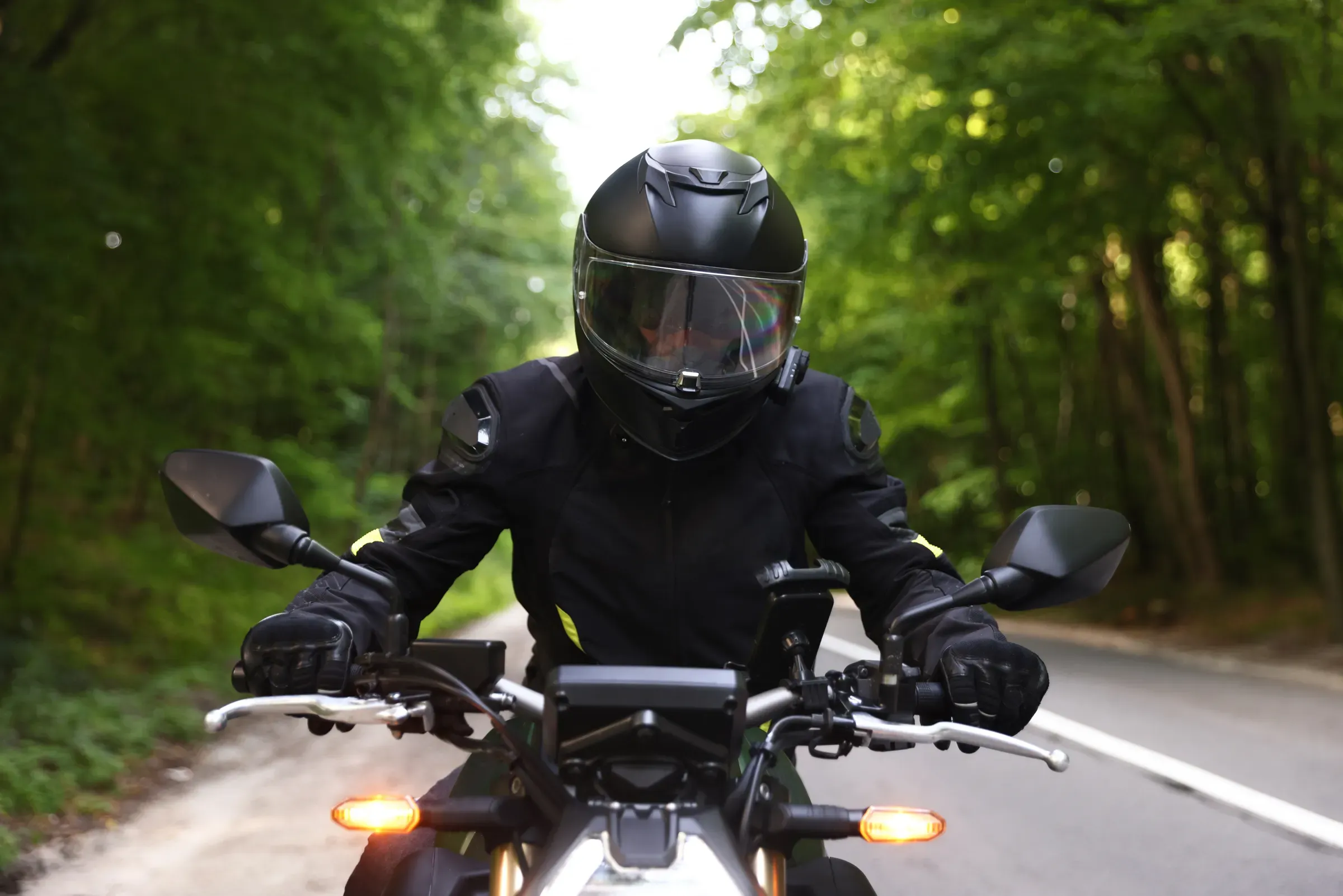 Young man in helmet driving modern motorcycle outdoors, motorcycle gear & parts ecommerce