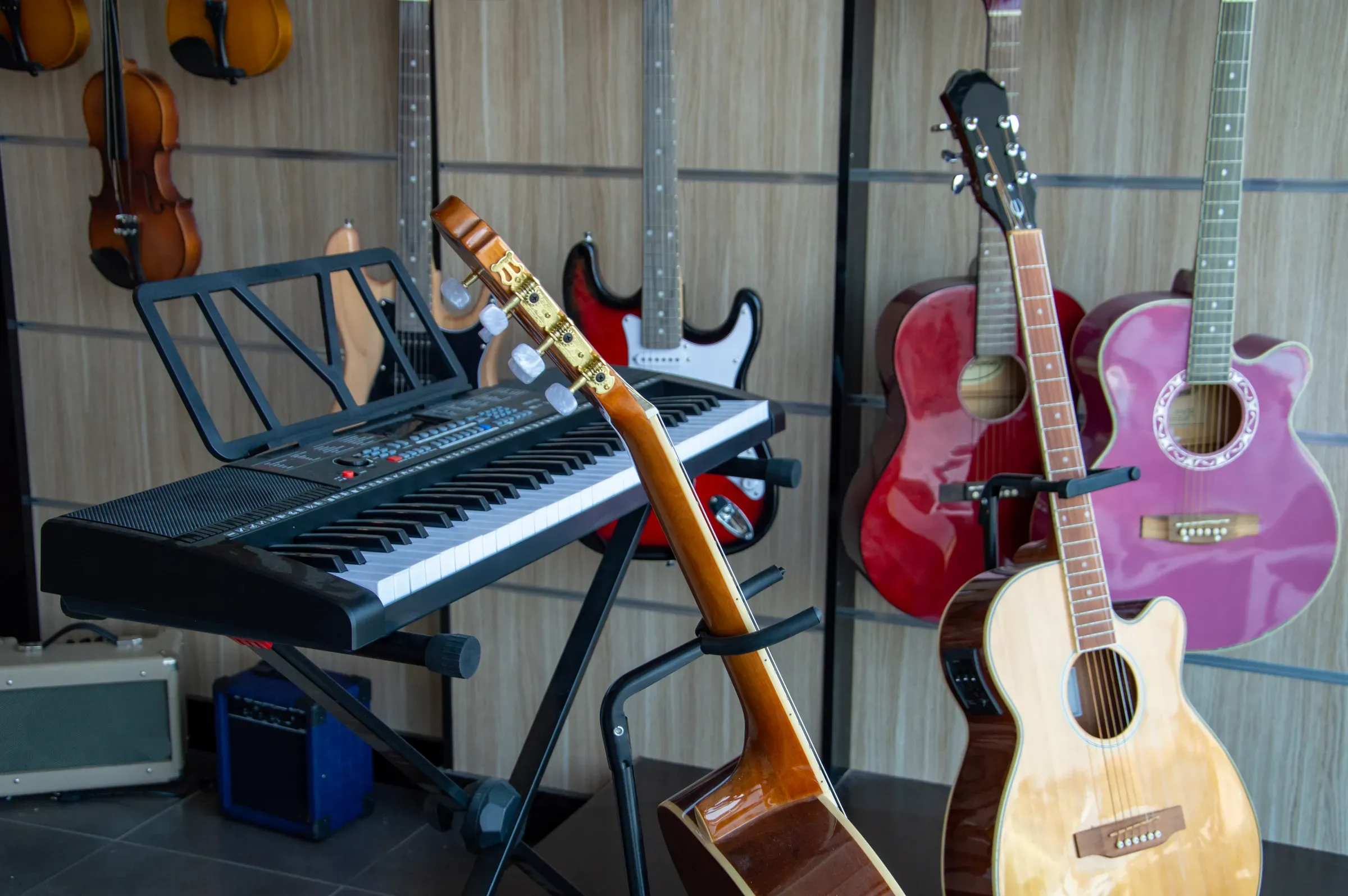 Acoustic guitars, violins, piano in the music store, musical instruments ecommerce