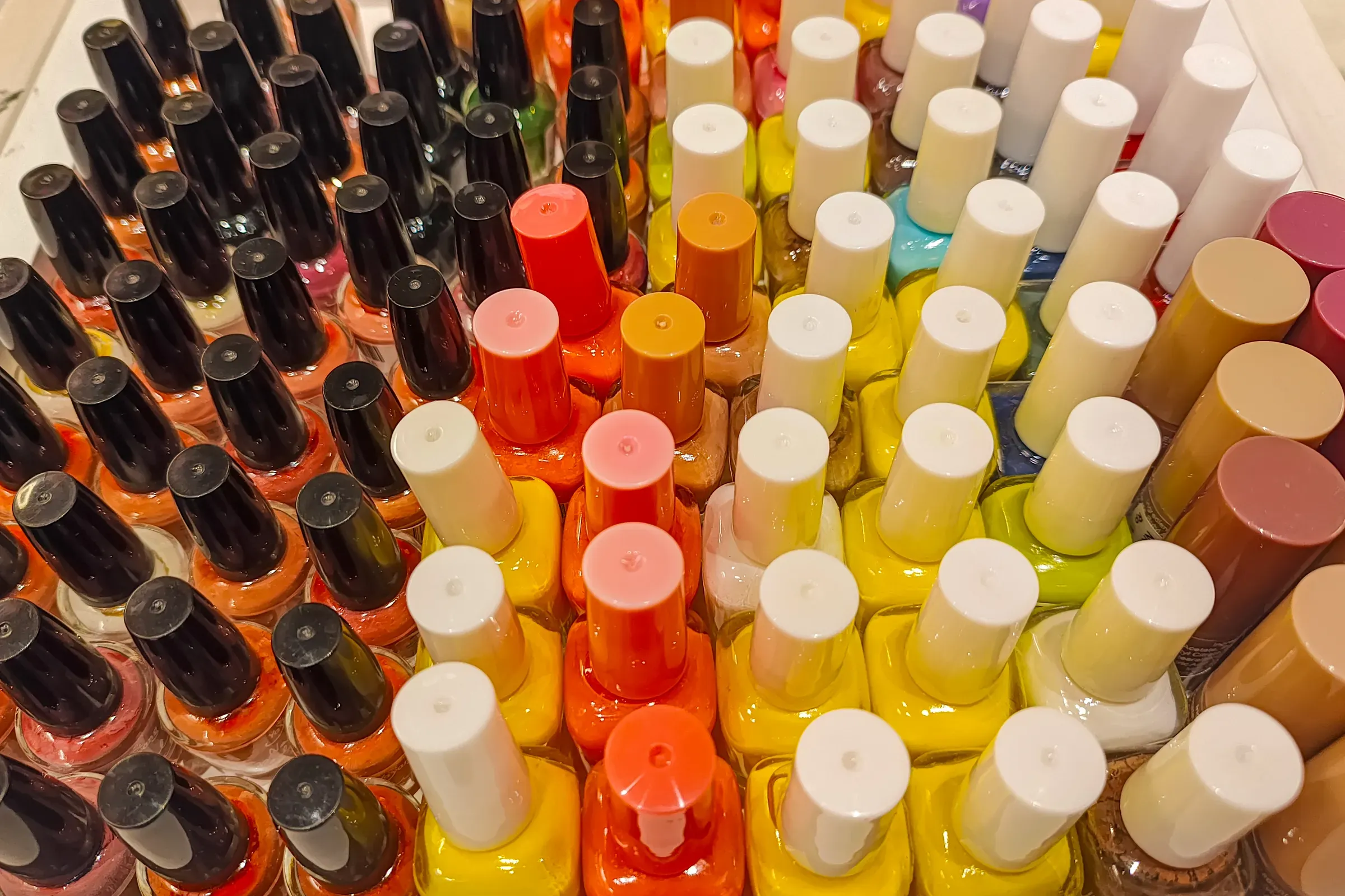 Vibrant Assortment of Colorful Nail Polish Bottles in a Display, nail polish & press-ons ecommerce