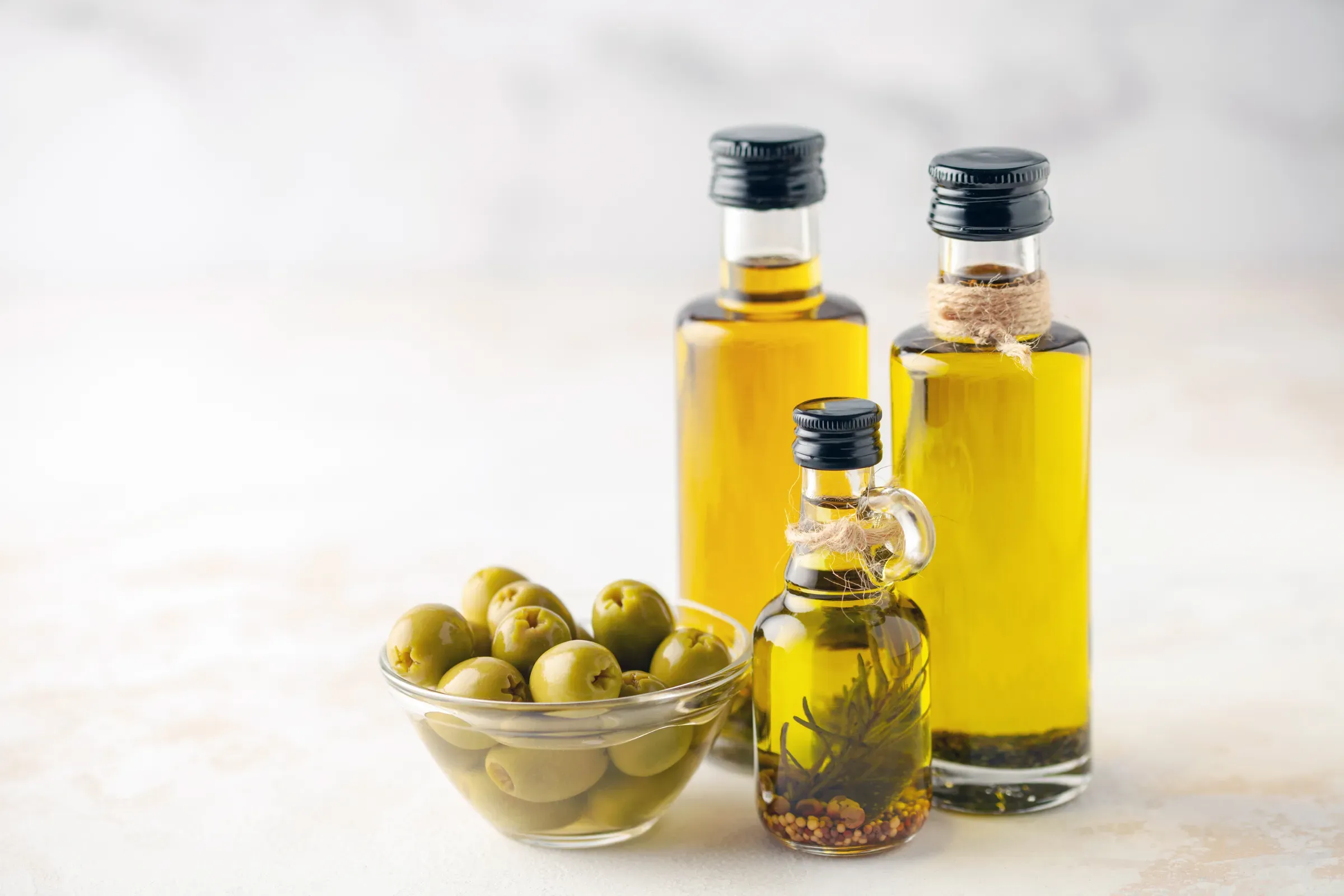 Olives oil in bottles on a bright background, olive oil & pantry ecommerce