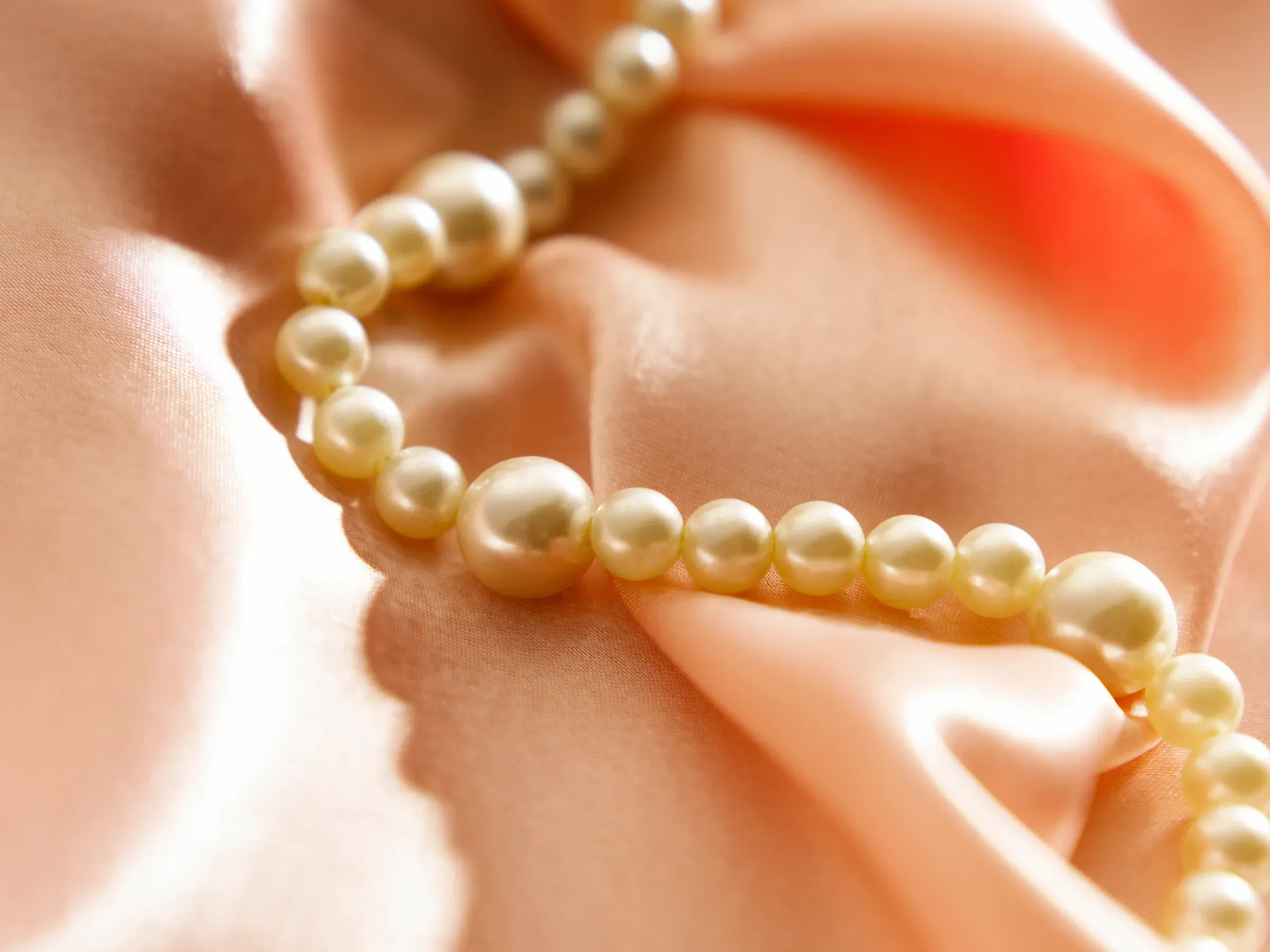 Close up pearl necklace on the satin, pearl jewelry ecommerce