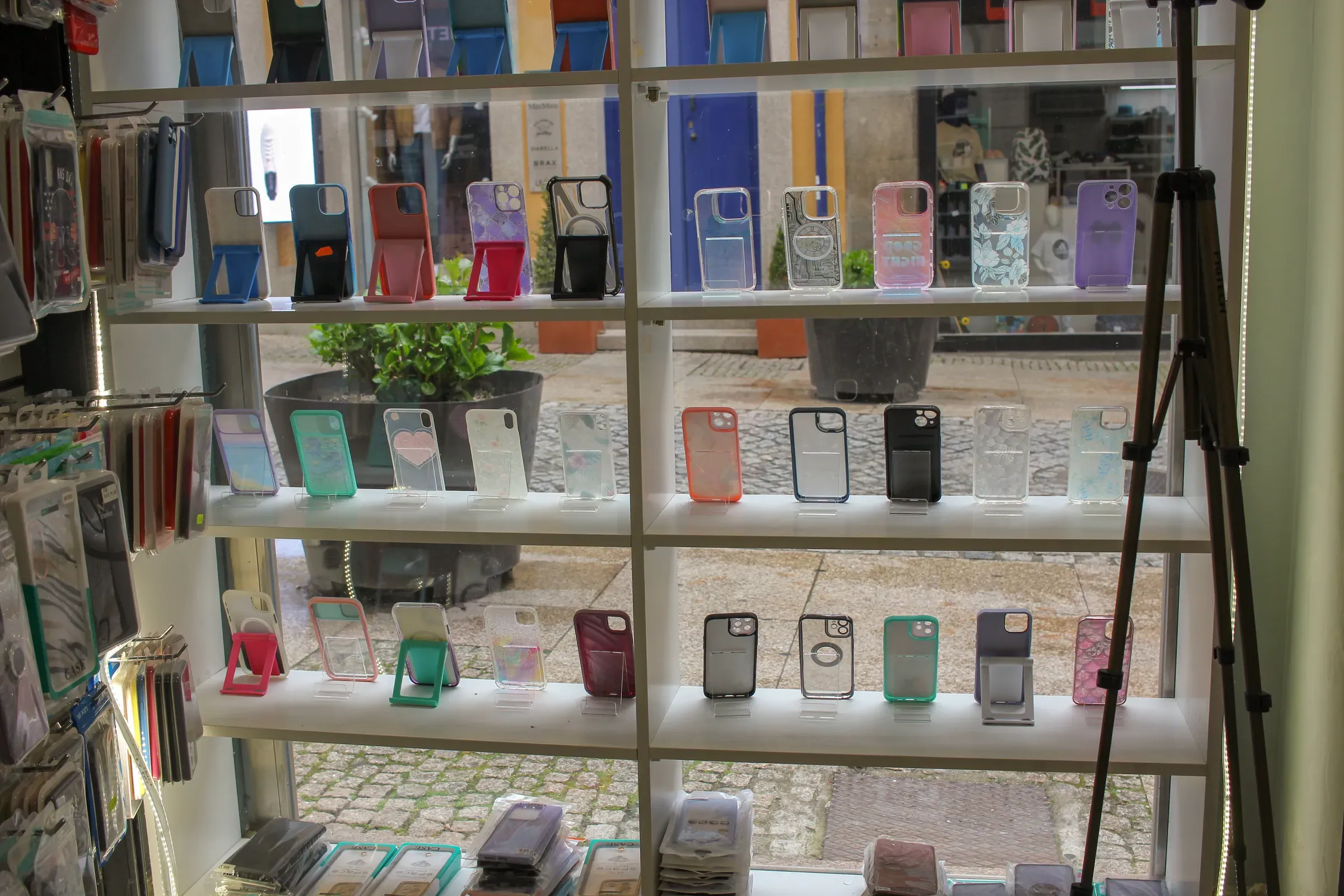 Display window with colorful mobile phone cases and covers in a retail store, phone cases & accessories ecommerce