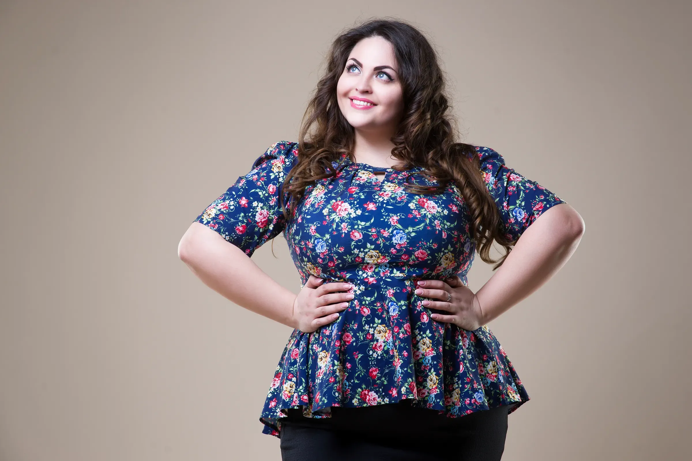 Plus size fashion model in casual clothes, fat woman on beige studio background, overweight female body, plus-size fashion ecommerce