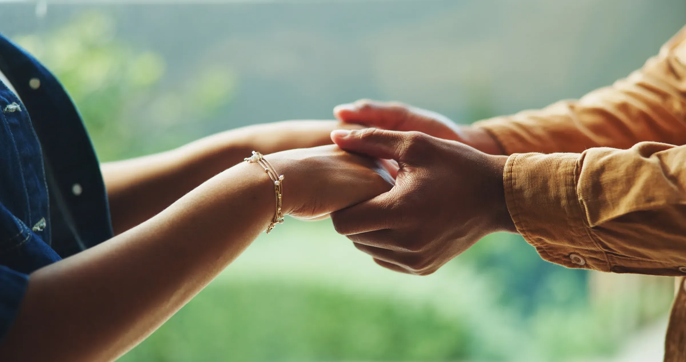 Love, couple and holding hands outdoor for trust, relationship wellness and safety together. Connection, man, sexual wellness ecommerce