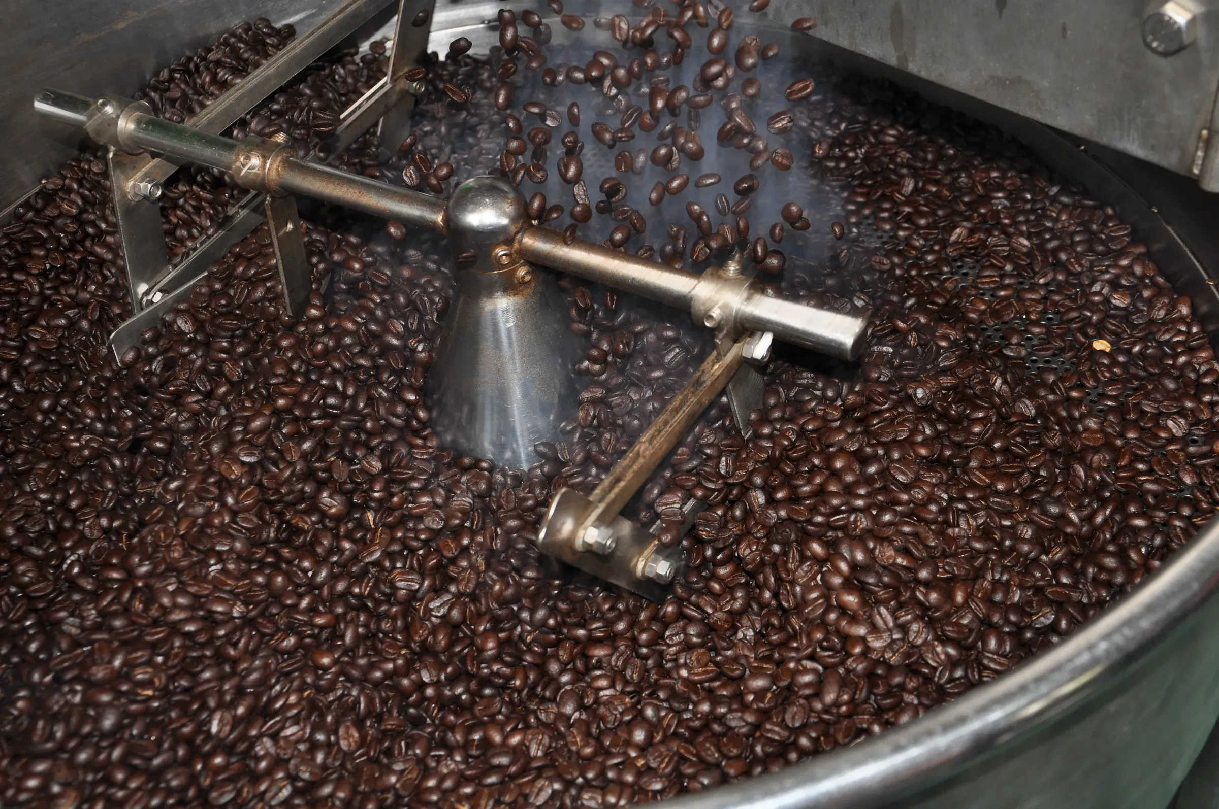 Coffee beans in a drum roaster in Thailand with the Karen, specialty coffee roasters ecommerce