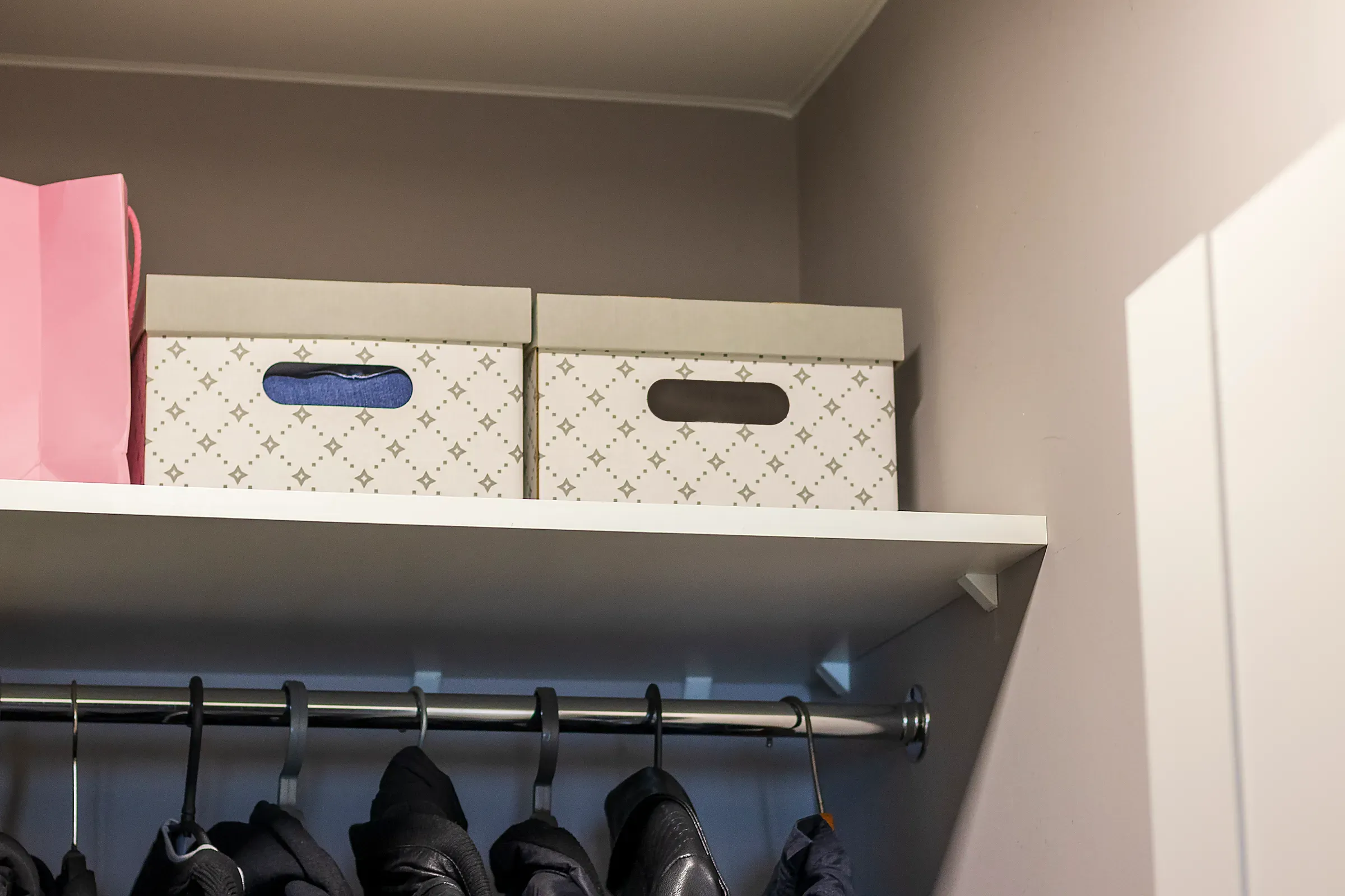 Storage boxes on the shelf in the closet room. Interior, storage & organization ecommerce