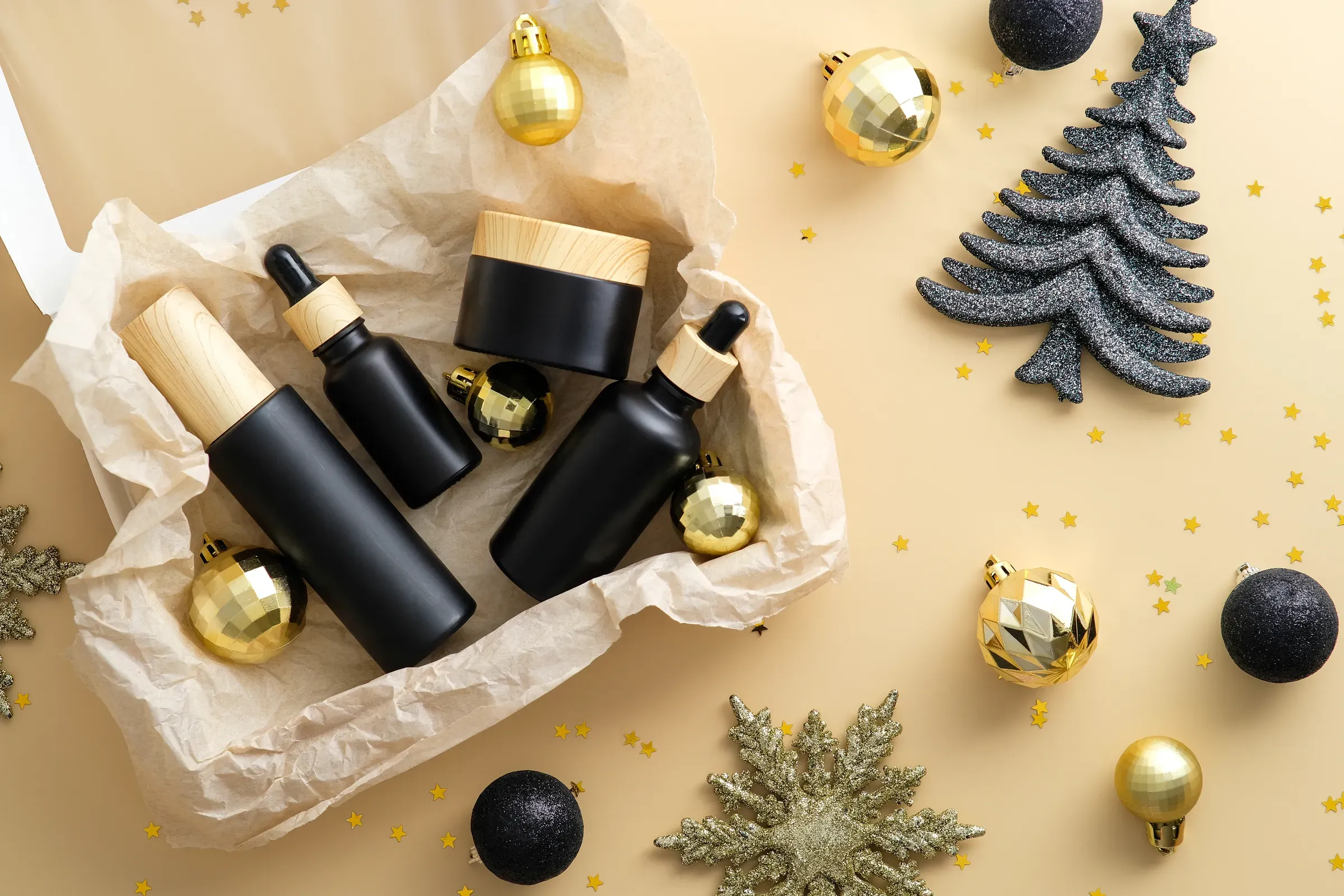 Subscription box with beauty products and Christmas decorations on beige background, subscription boxes ecommerce