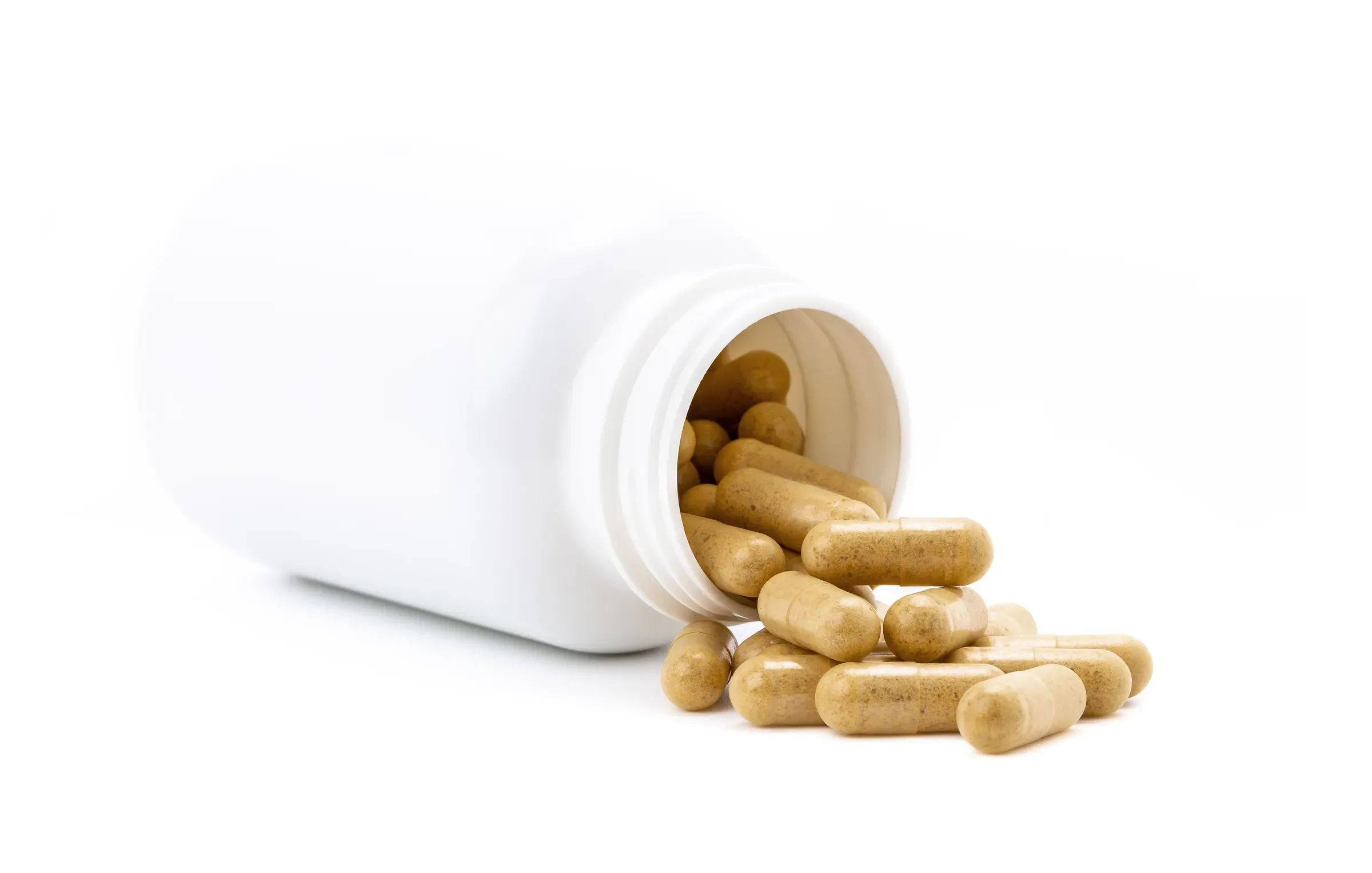 Brown herbal supplement capsules pour out from white opened plastic bottle, supplements ecommerce