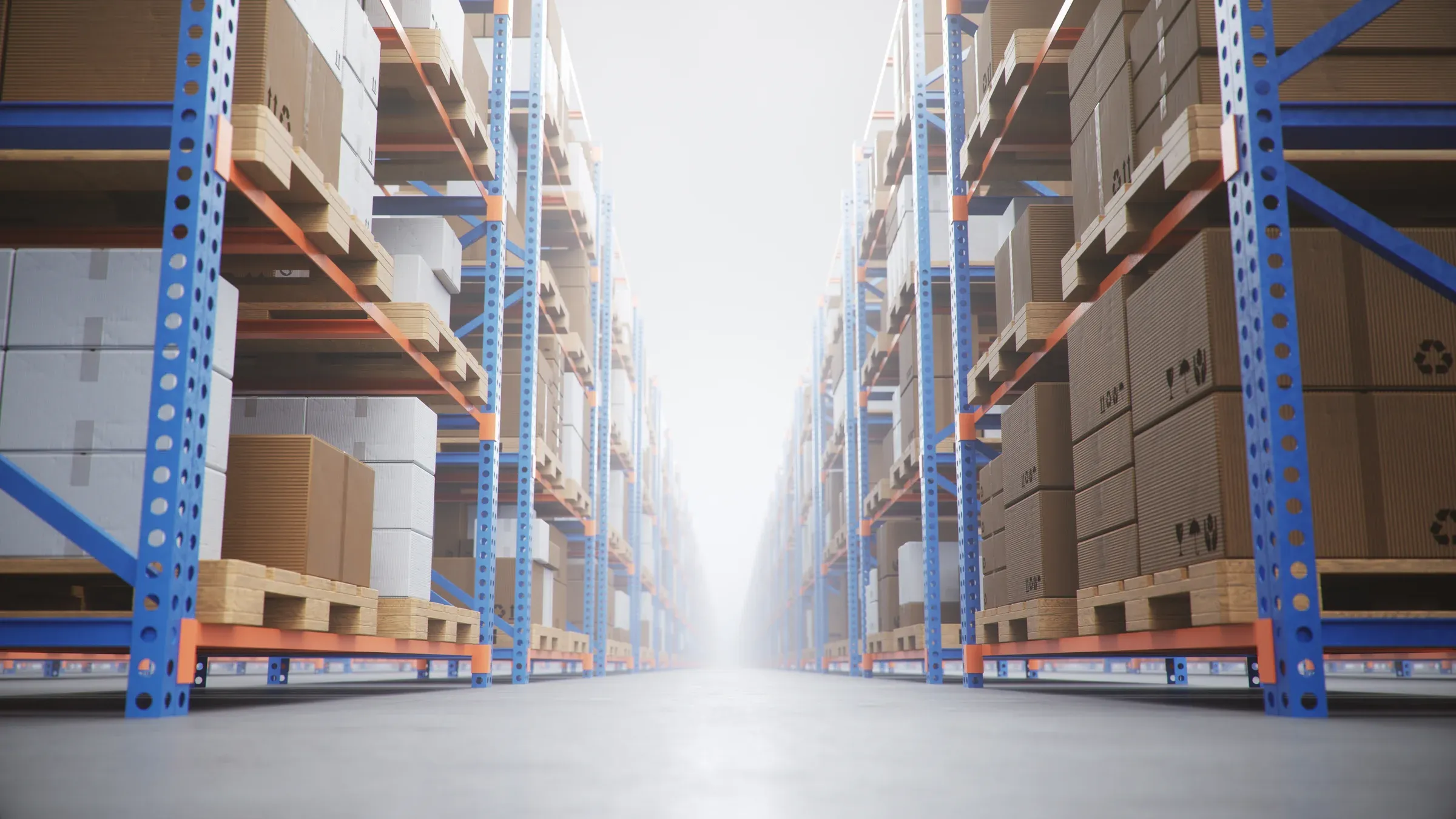 A distribution warehouse aisle of blue racking stacked with boxes