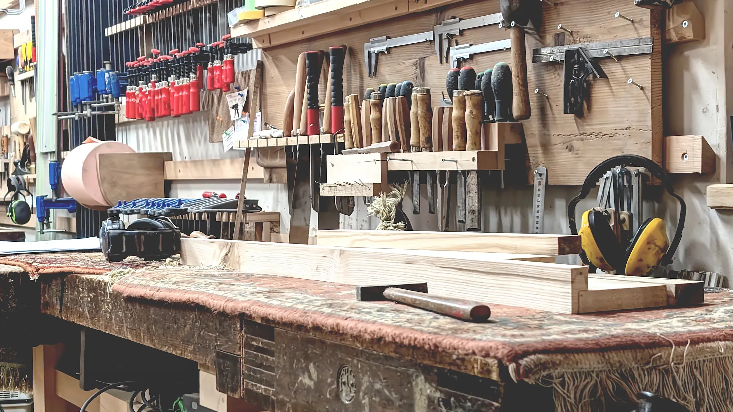 Woodworking tools arranged neatly in a rustic workshop with various hand tools, woodworking tools & plans ecommerce
